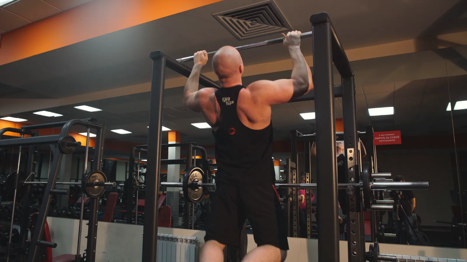 A man pulling his chin over the bar, one of Murph's 100 pull-ups